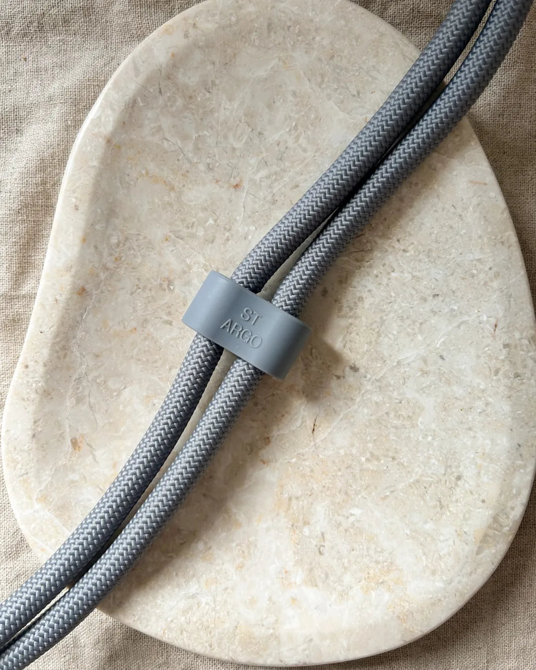 Luxury rope grey dog lead with 'ST ARGO' logo on a beige background