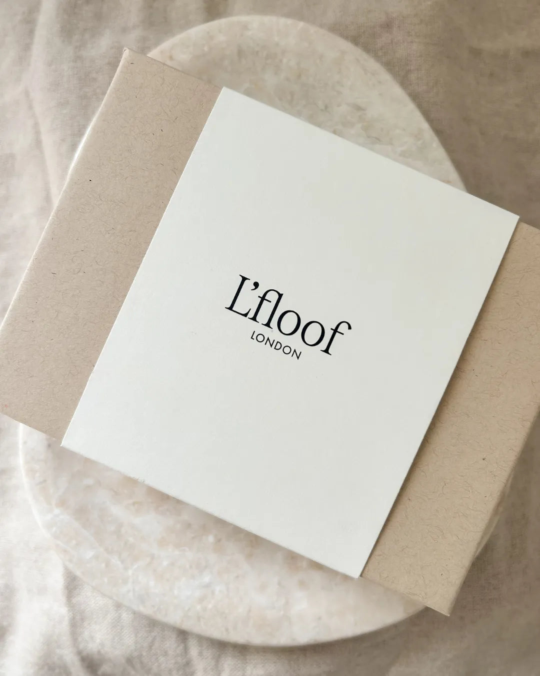 Product packaging with 'L'floof London' branding on a neutral background
