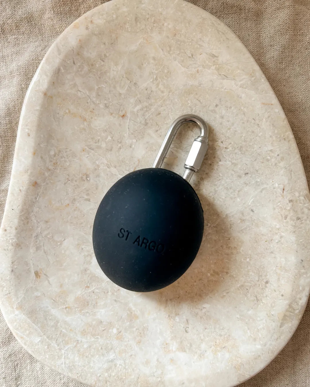 Luxury silicone dog treat pouch with a carabiner on a beige stone surface