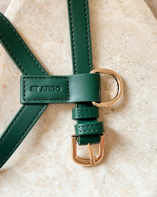 Luxury dark green vegan leather dog harness with gold hardware on a beige background