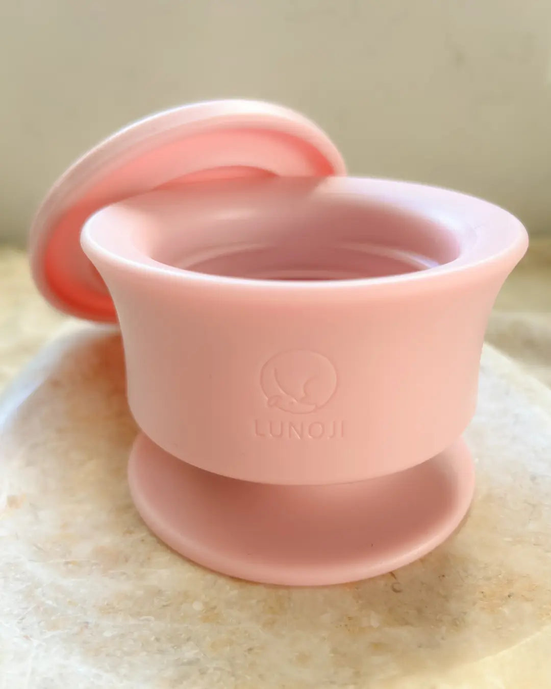 Pink dog enrichment pot with lid on a marble background
