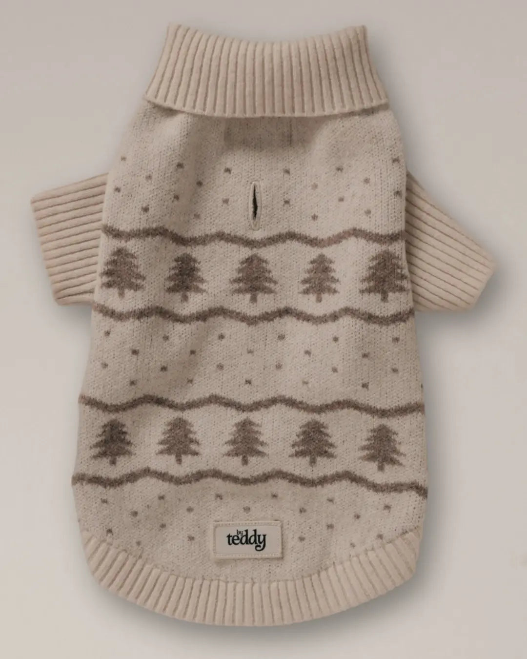 Beige knitted dog jumper with Christmas tree pattern on a light grey background